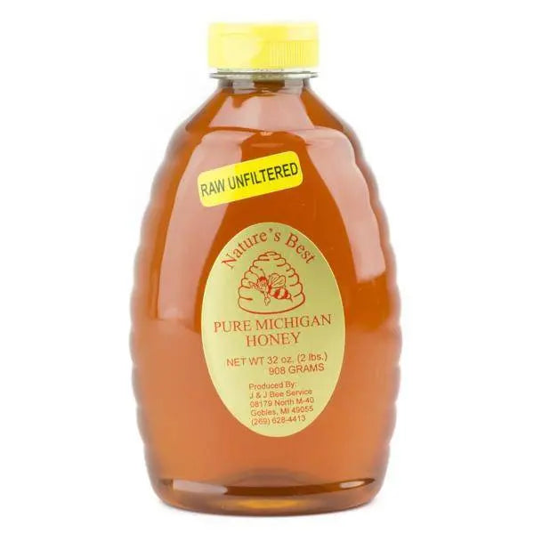 Jar of raw unfiltered honey with golden color and natural texture